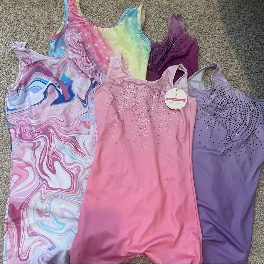 Girls leotards sizes 8-9, great condition. 5 sets total, one still with tag.